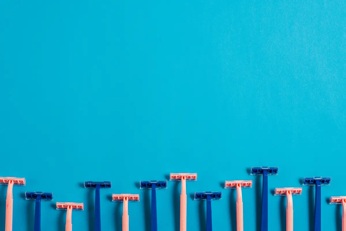 Bottom border made with pink and blue razors on blue backdrop